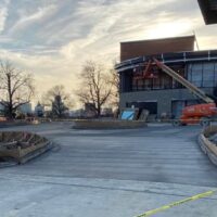 Photo of Don Markesbery Playhouse in the Park commercial concrete project with partly cloudy sky and orange construction crane in background, large concrete platform in foreground